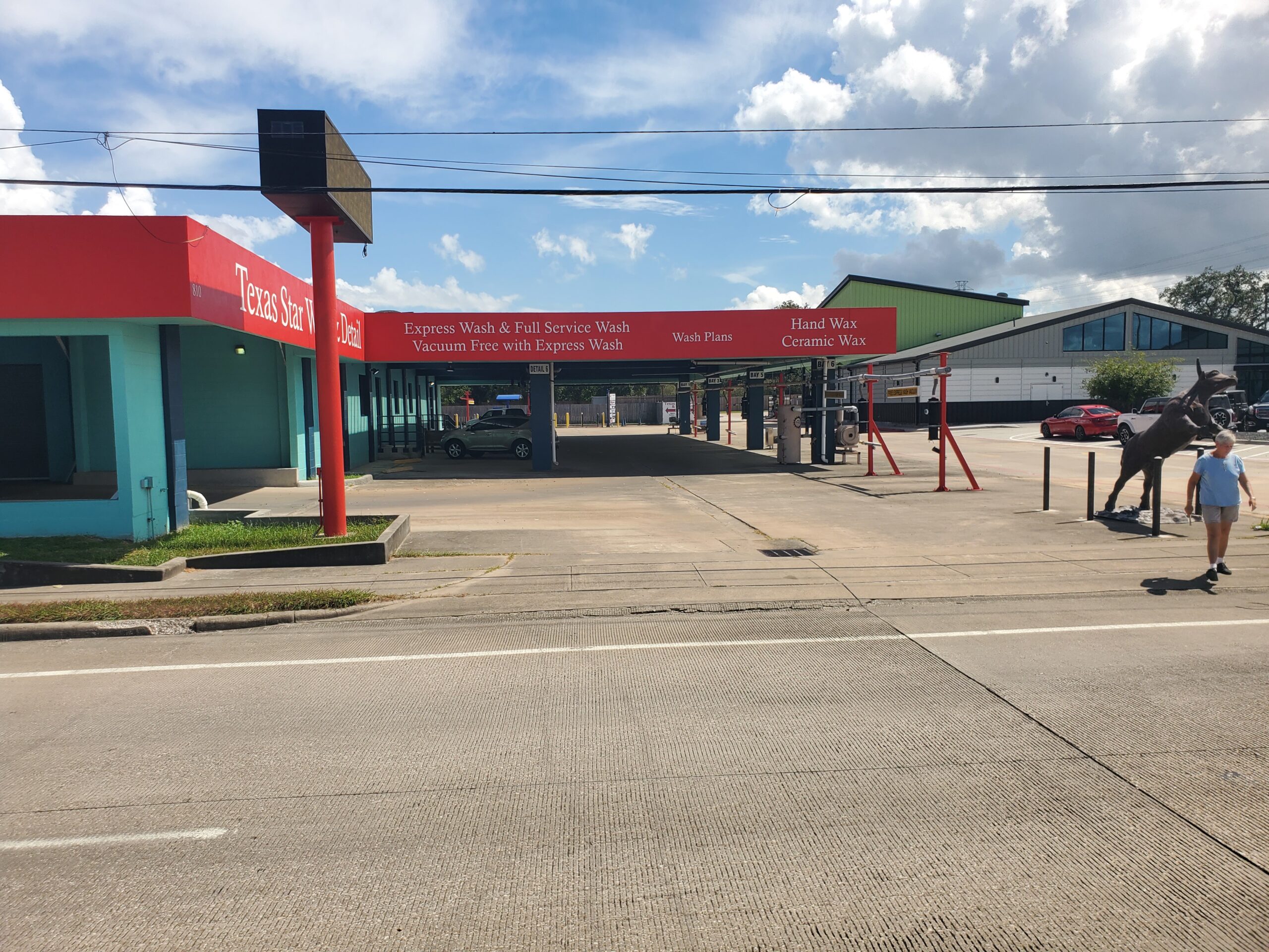 Large brushes cleaning a car.