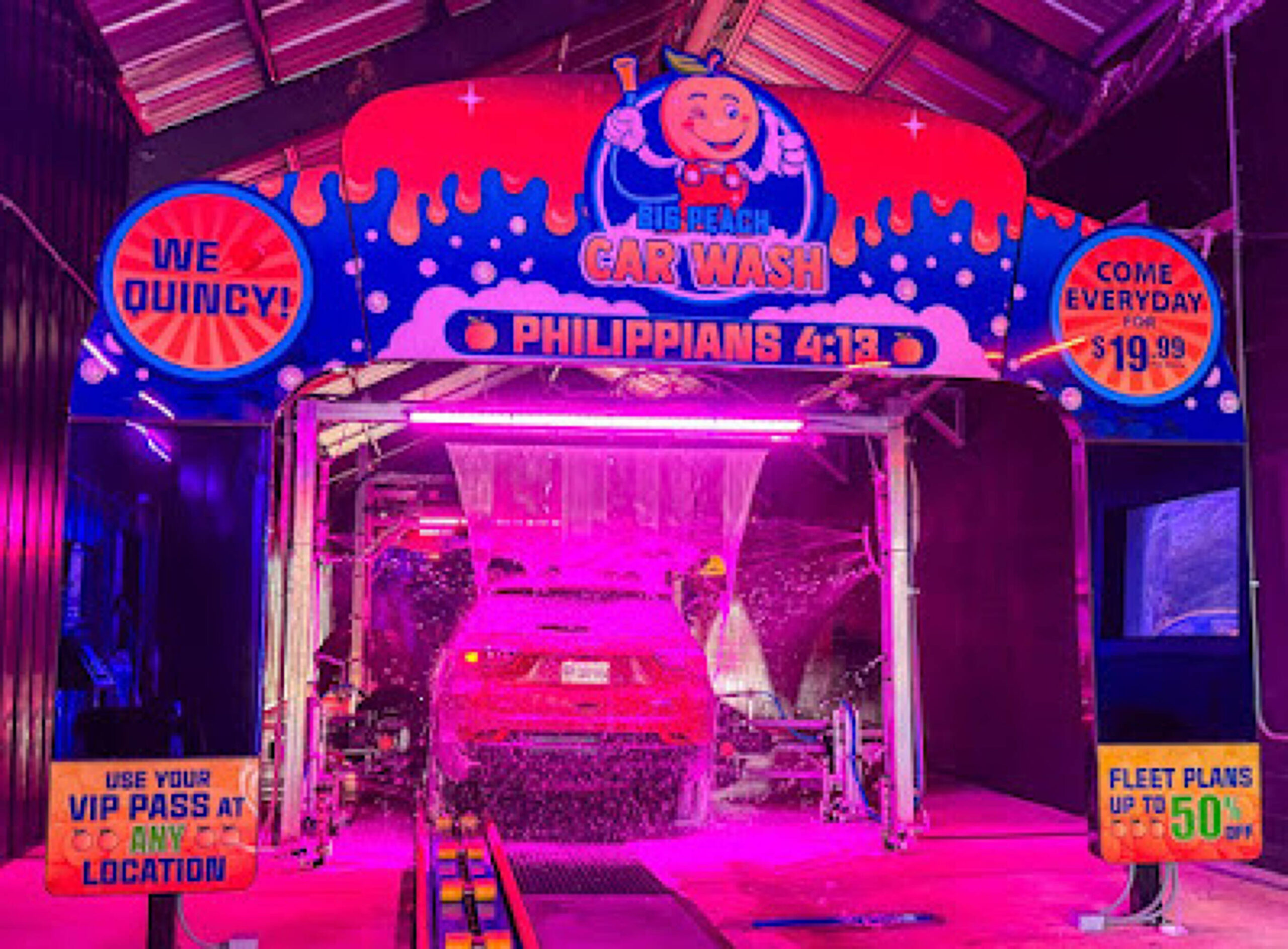 Large brushes cleaning a car.