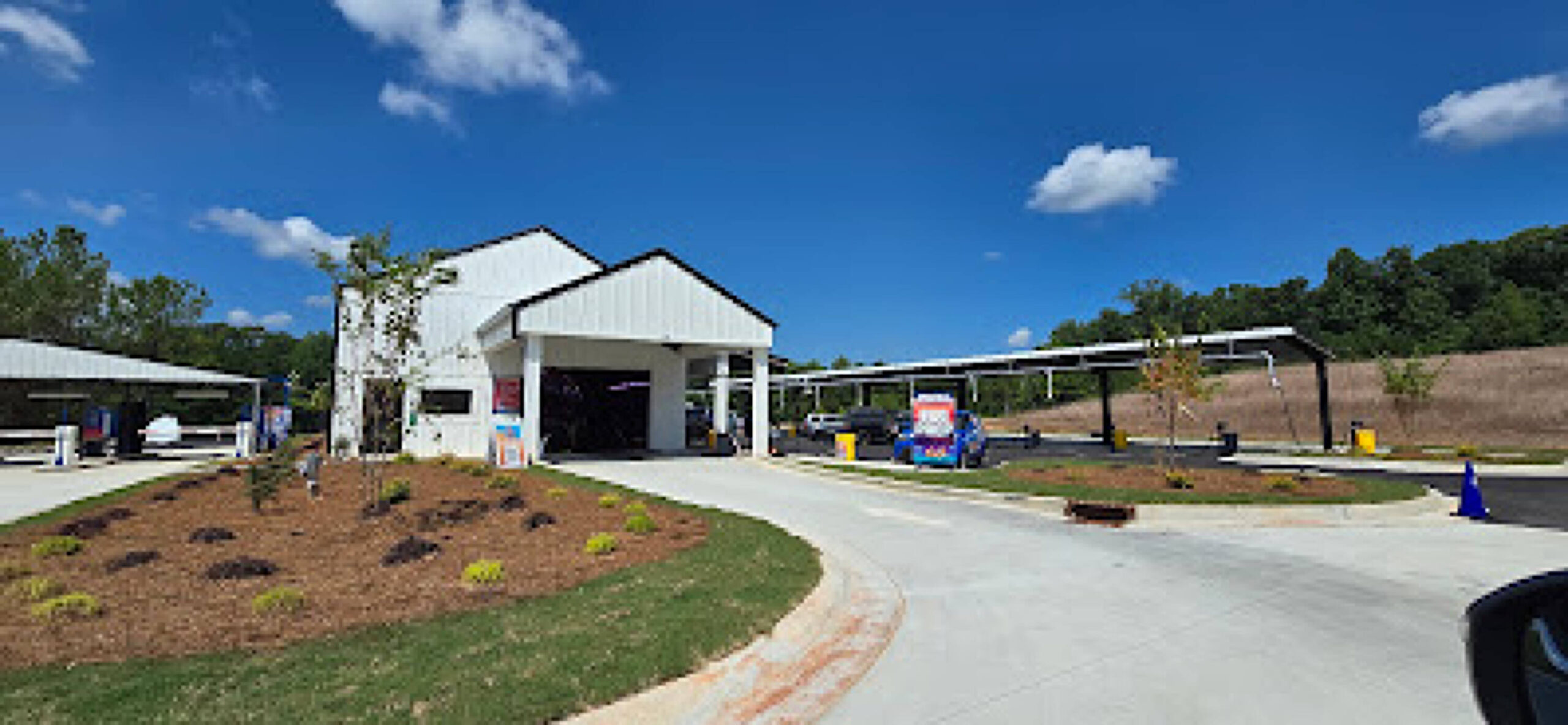 Large brushes cleaning a car.