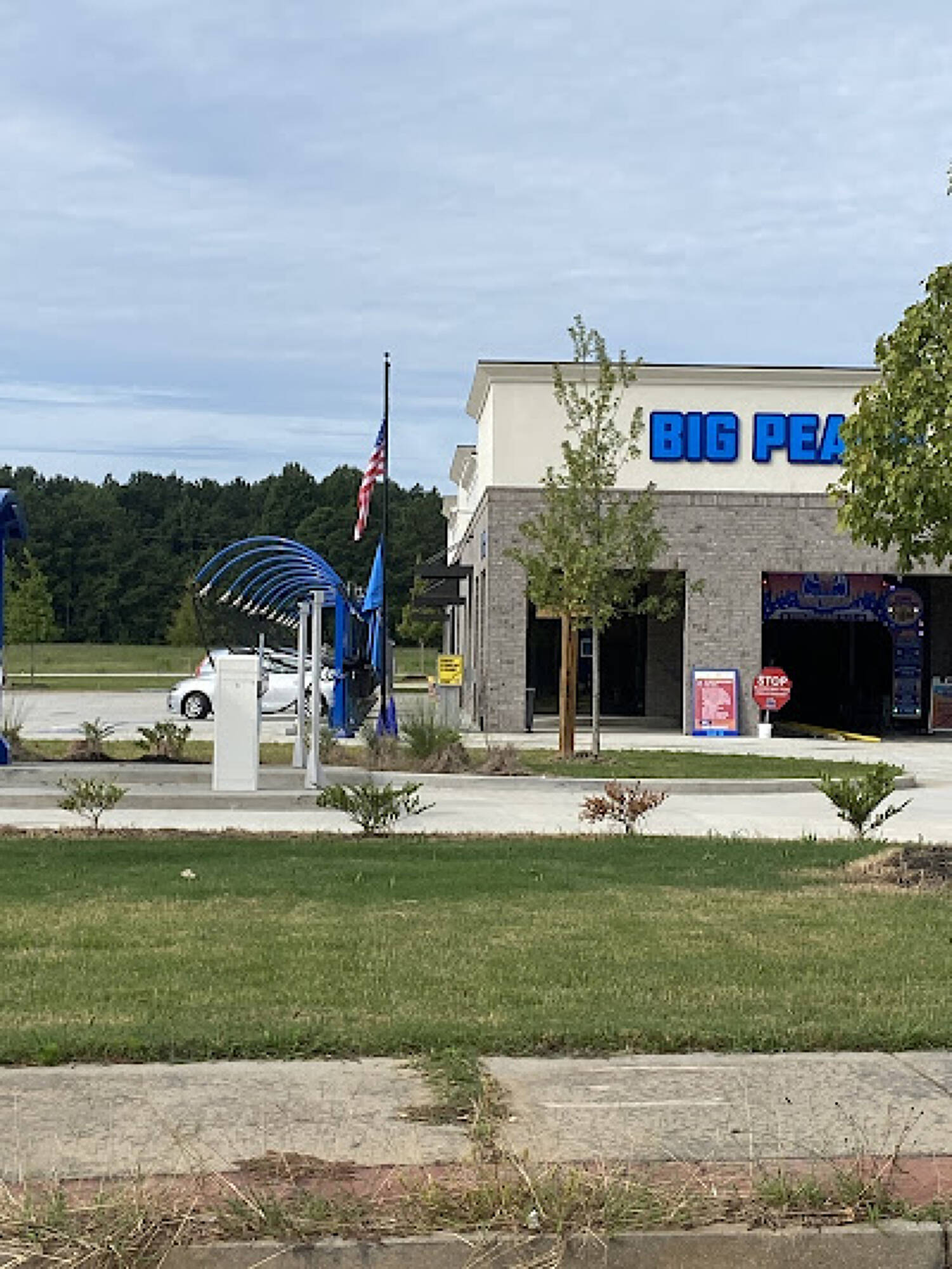 Large brushes cleaning a car.