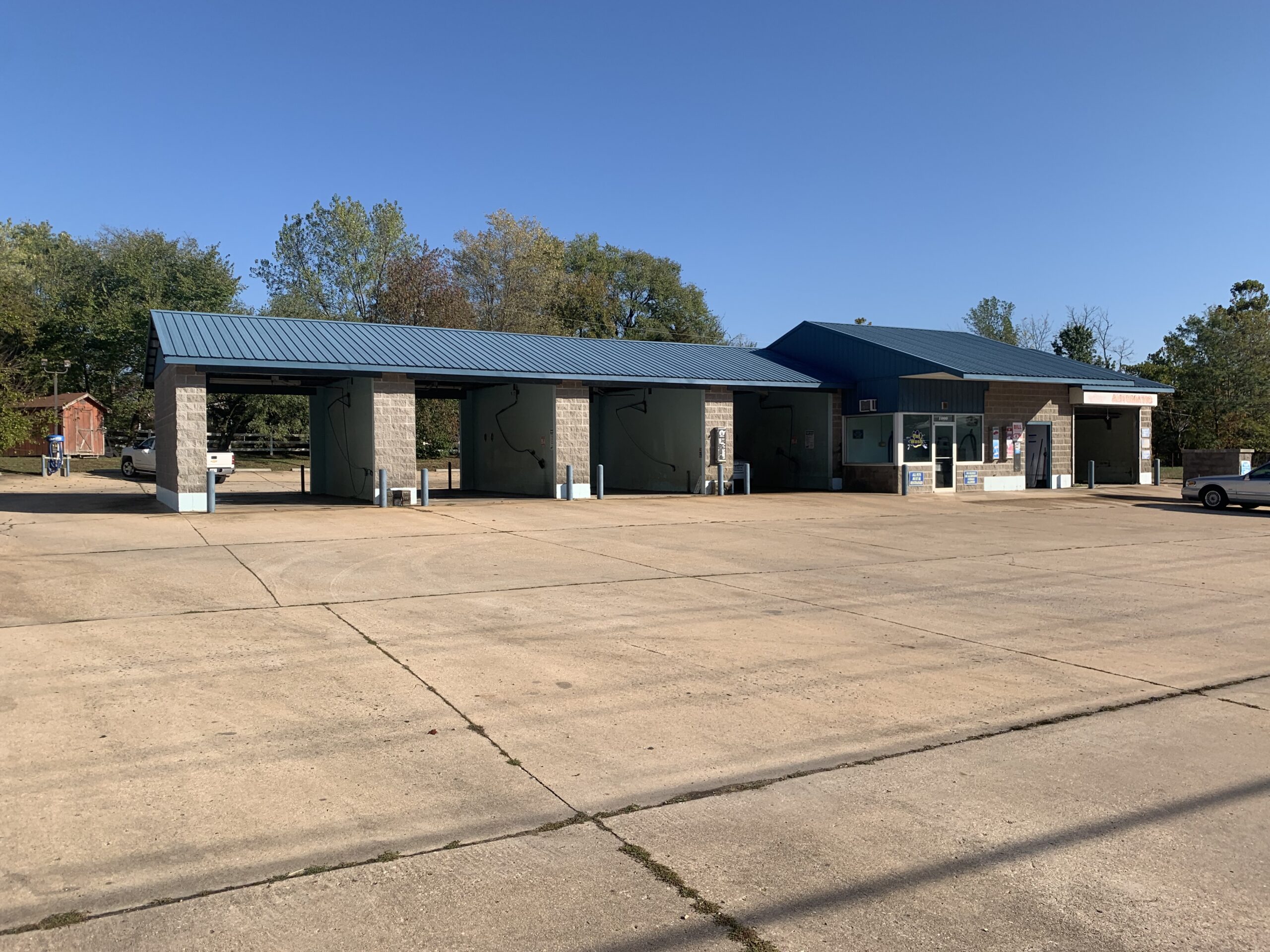 Large brushes cleaning a car.