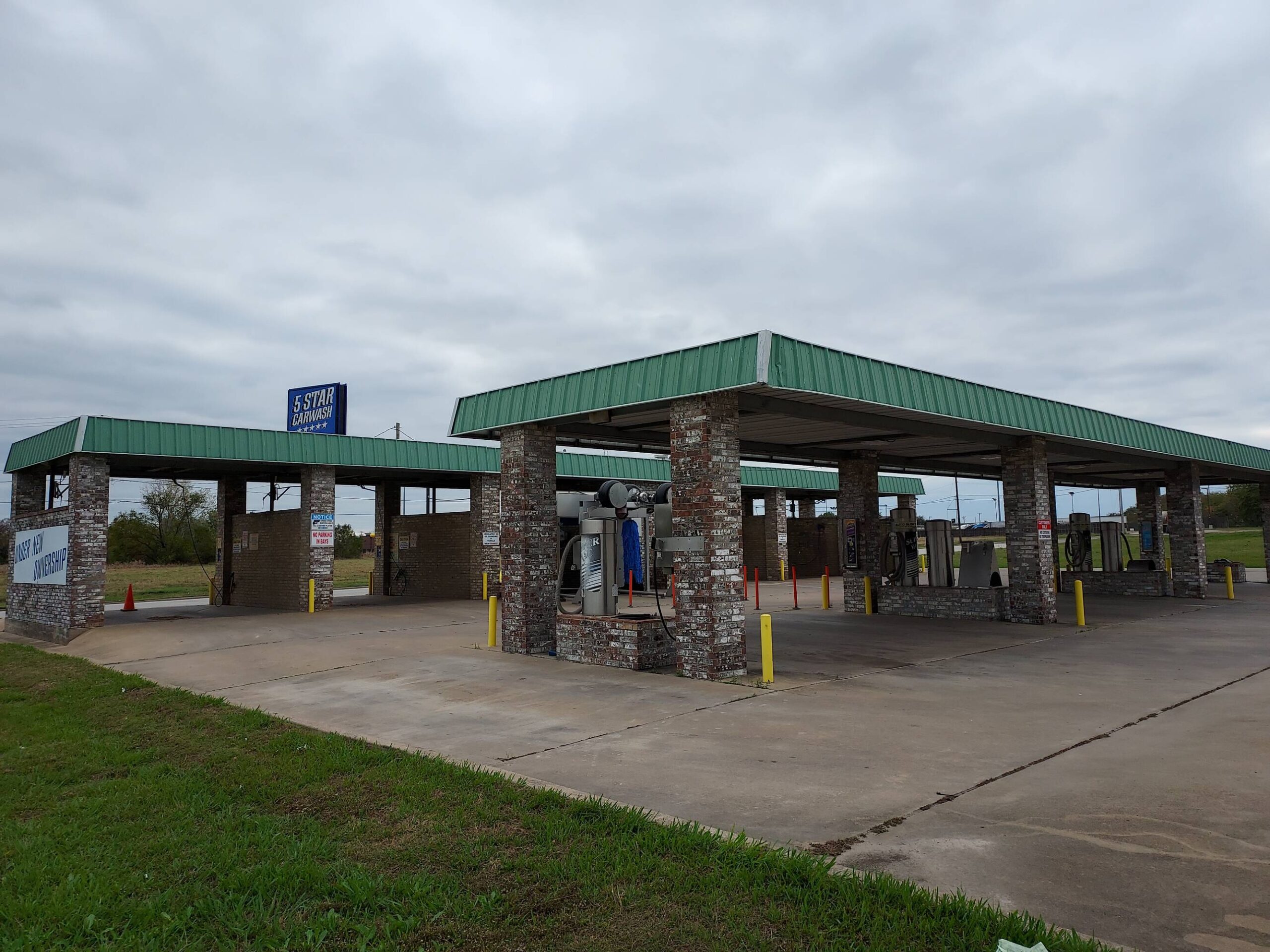 Large brushes cleaning a car.