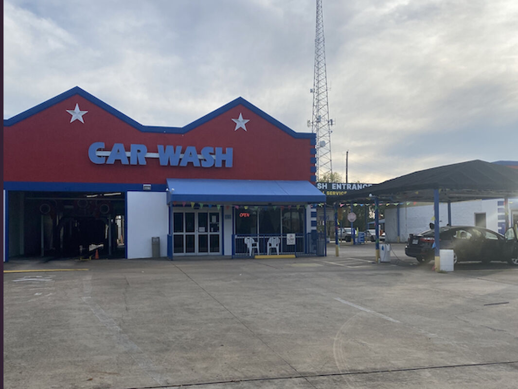 Large brushes cleaning a car.