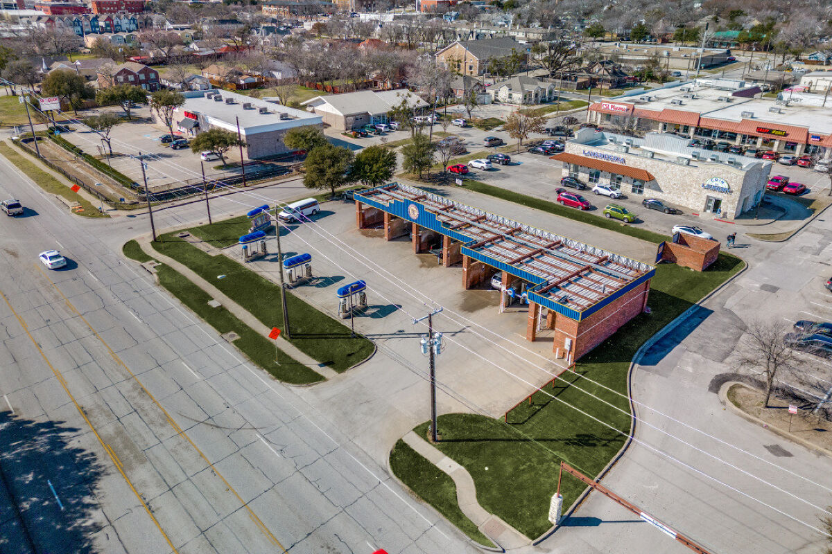 Large brushes cleaning a car.