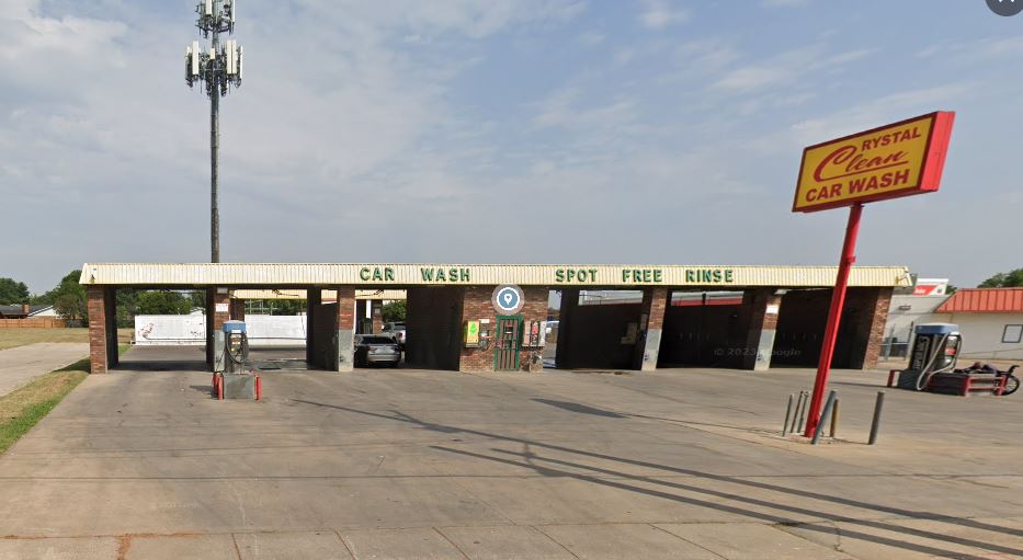 Large brushes cleaning a car.
