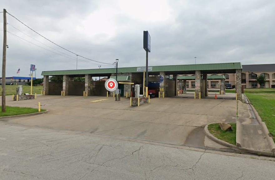 Large brushes cleaning a car.