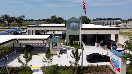 Large brushes cleaning a car.