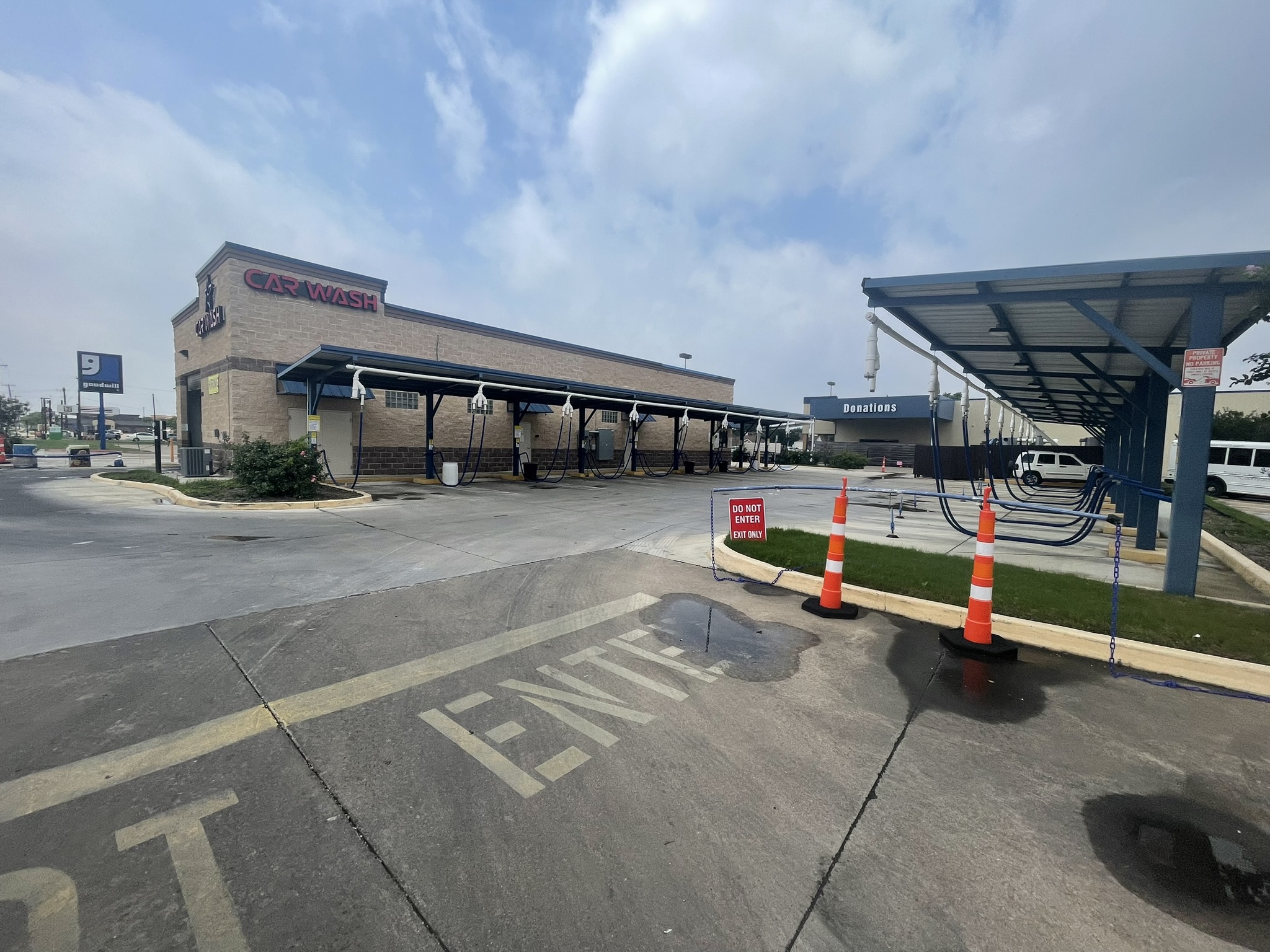 Large brushes cleaning a car.