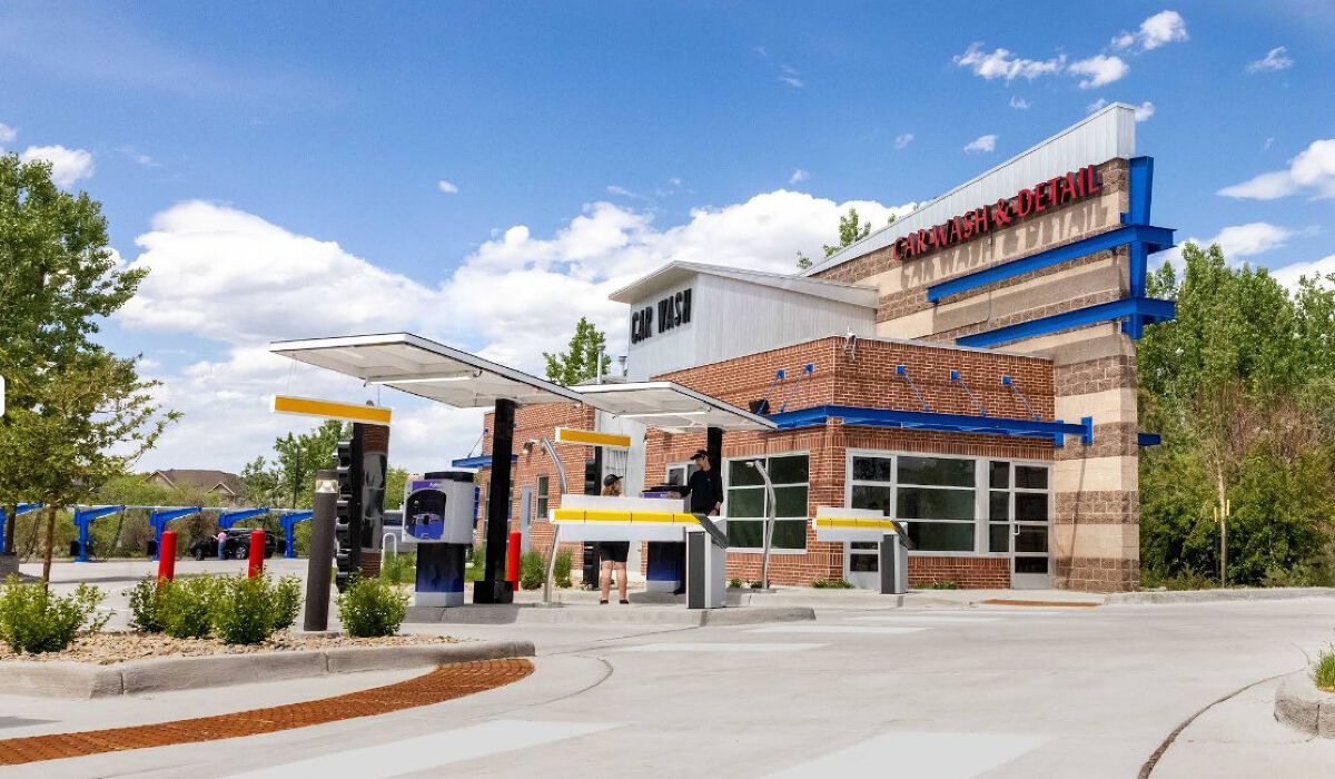 Large brushes cleaning a car.