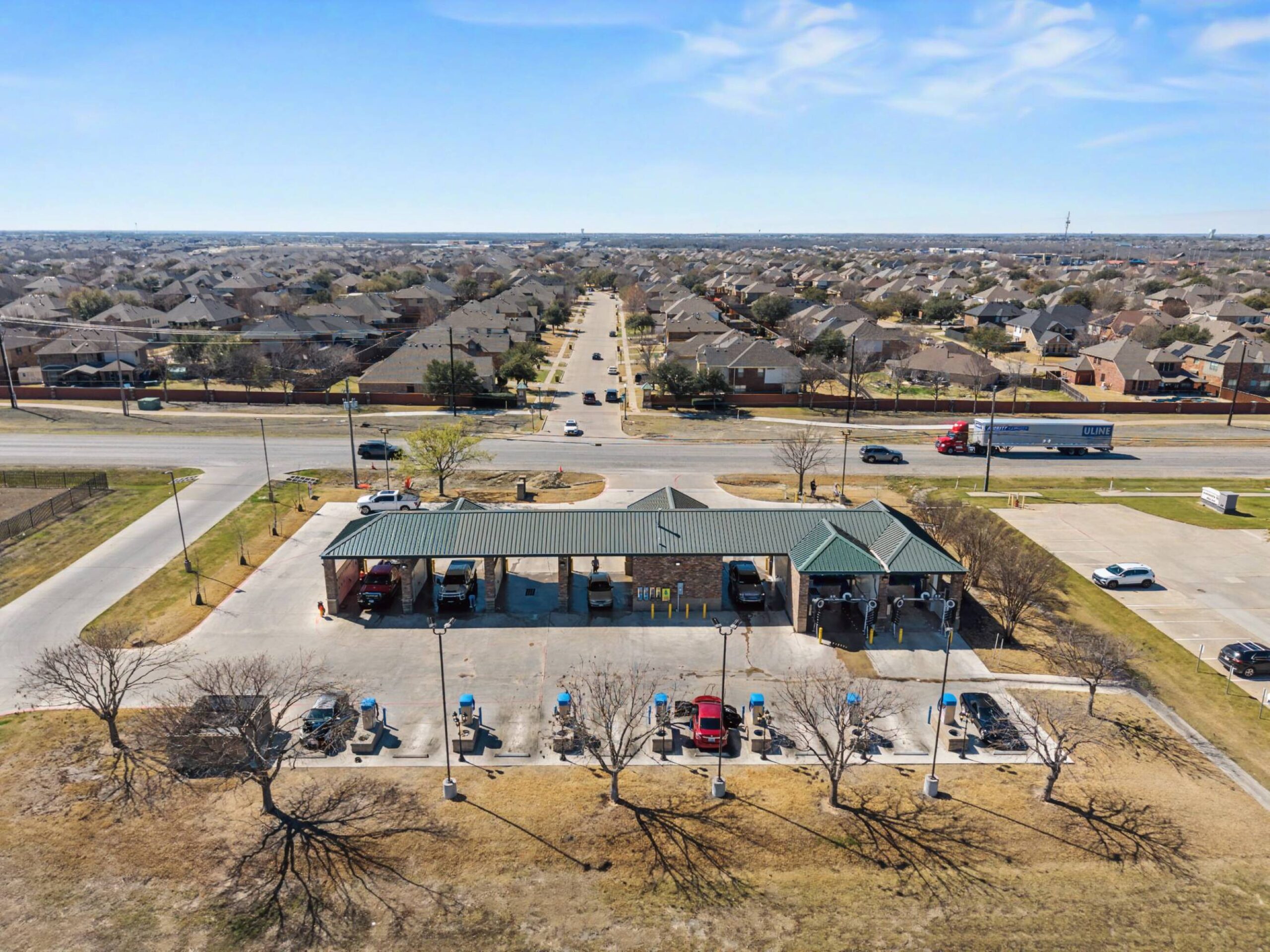 Large brushes cleaning a car.