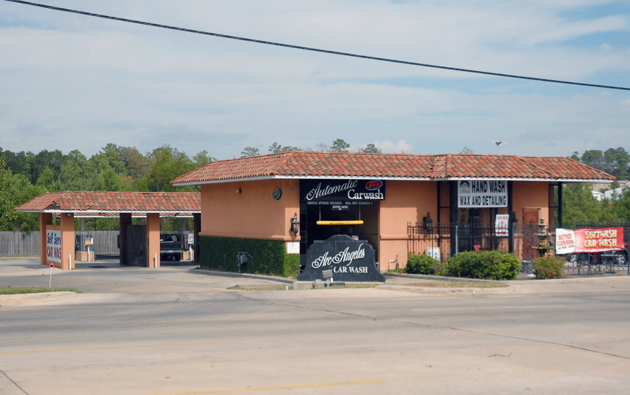 Large brushes cleaning a car.