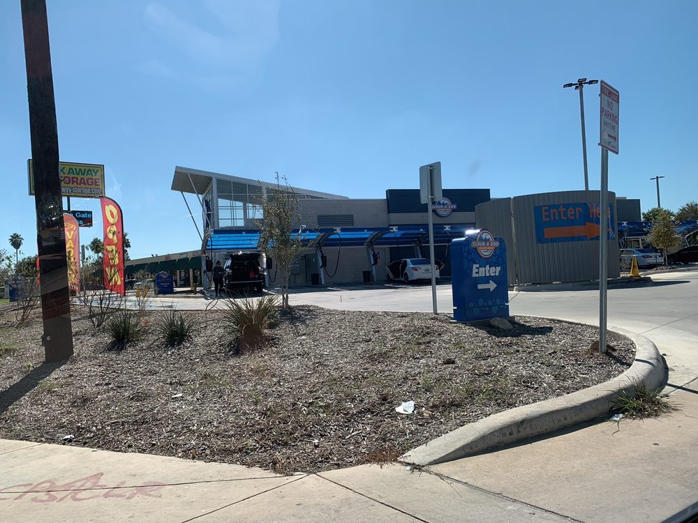 Large brushes cleaning a car.