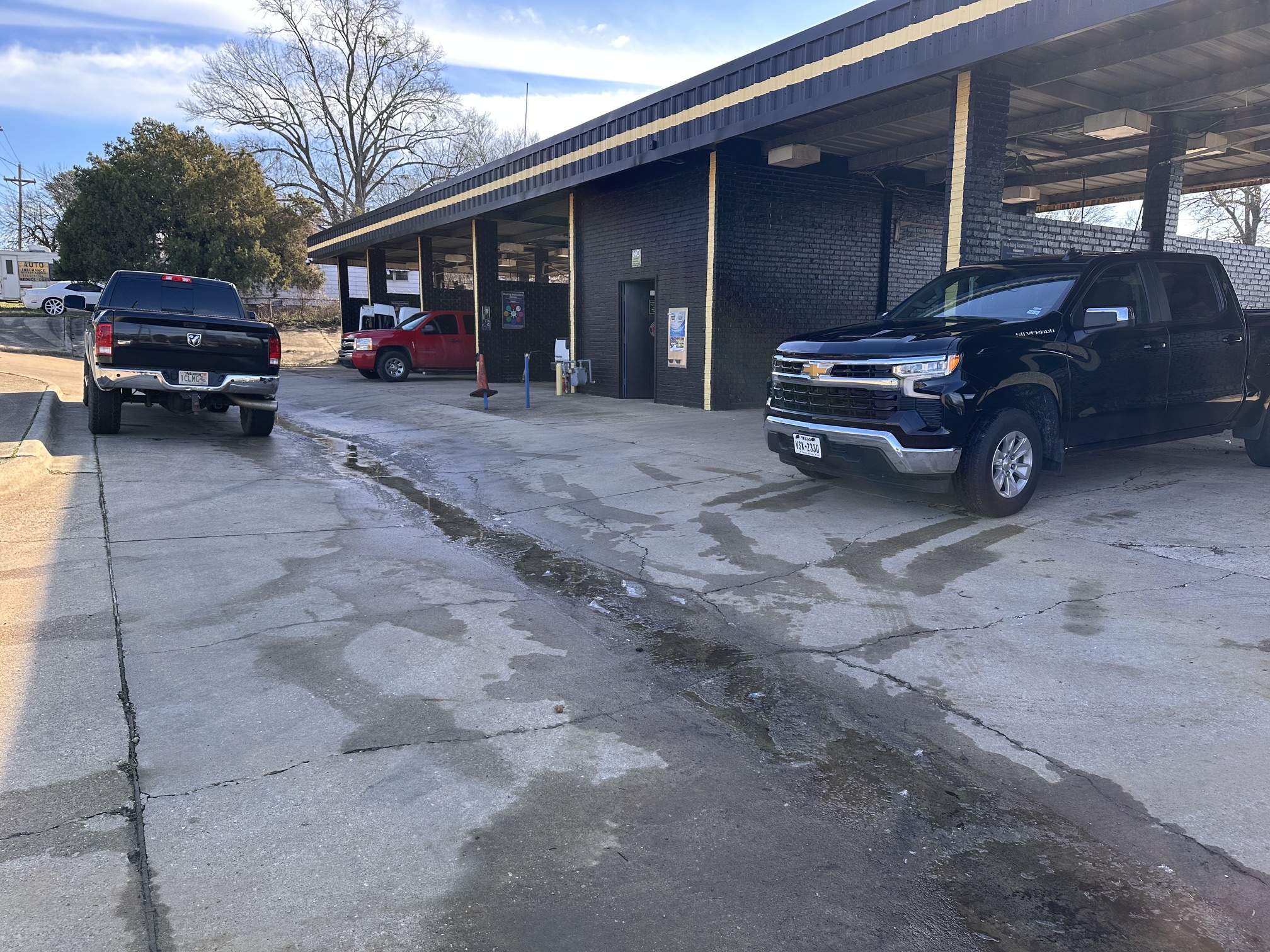Large brushes cleaning a car.
